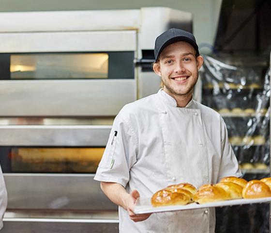 image of a person with a tray of pastries
