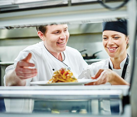 image of chefs talking in commercial kitchen